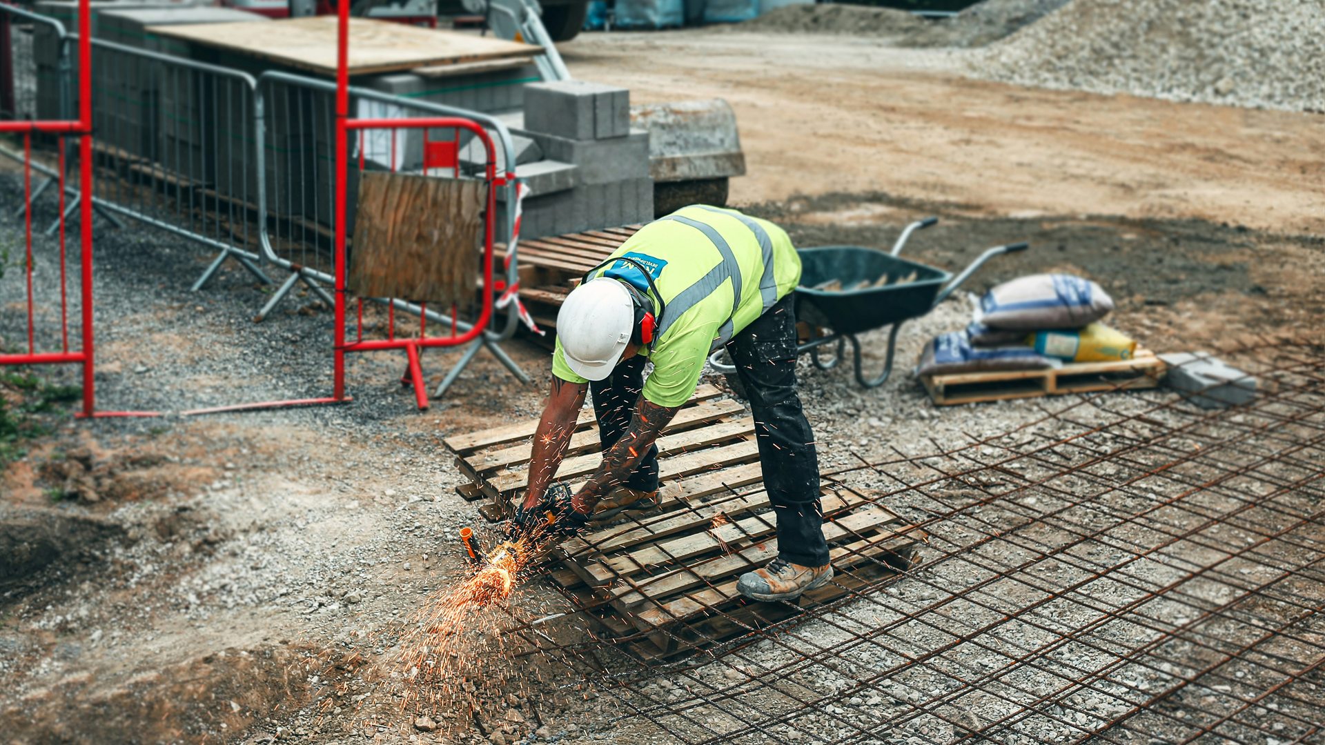 Worker cutting reinforcing steel on a residential construction site