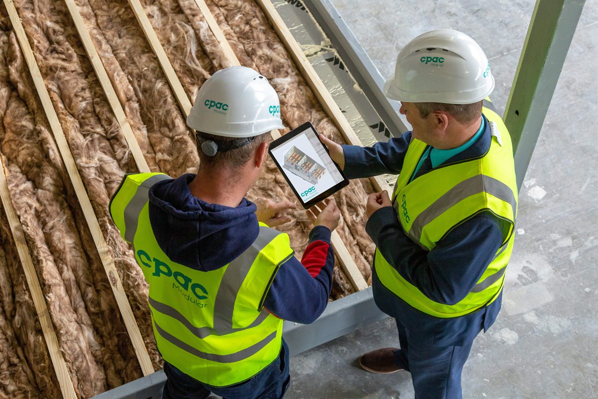 Construction team reviewing building plans on site
