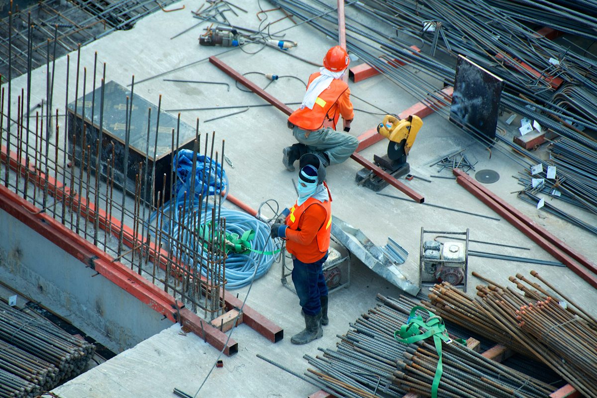 Workers preparing reinforcing steel on a building site