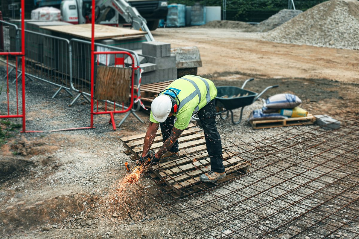 Worker cutting reinforcing steel on a building site